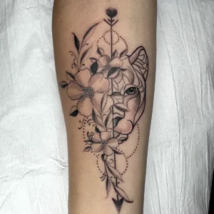 lion and flowers tattoo in Nero Tattoo Parlour